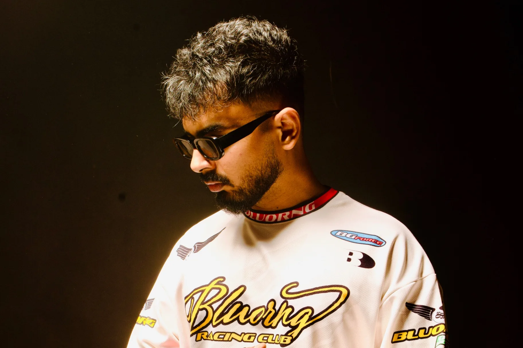 Max in a Bluorng racing jersey, side profile studio shot.