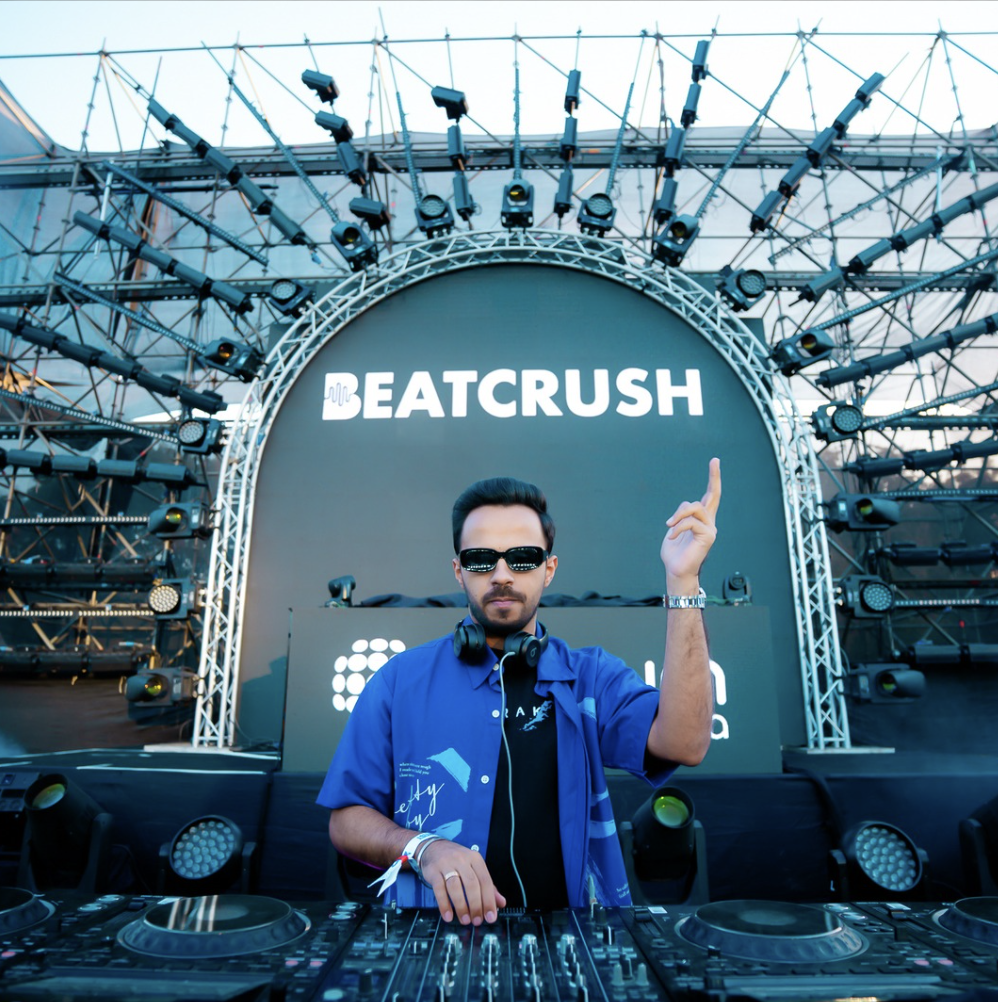 BeatCrush on the main stage under the BEATCRUSH arch, festival lighting rig behind him.