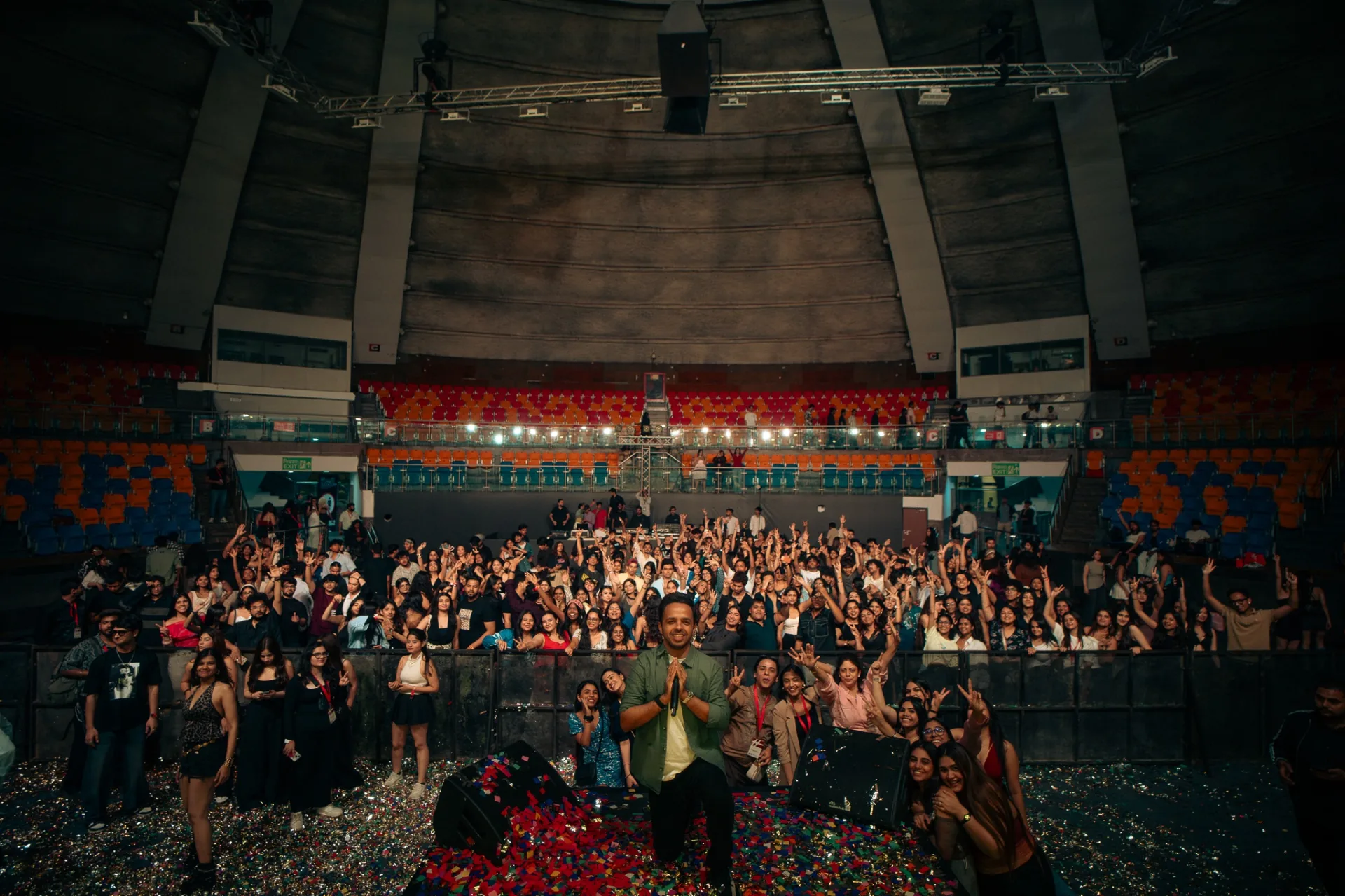 BeatCrush on stage in front of a packed arena crowd, confetti covering the floor.