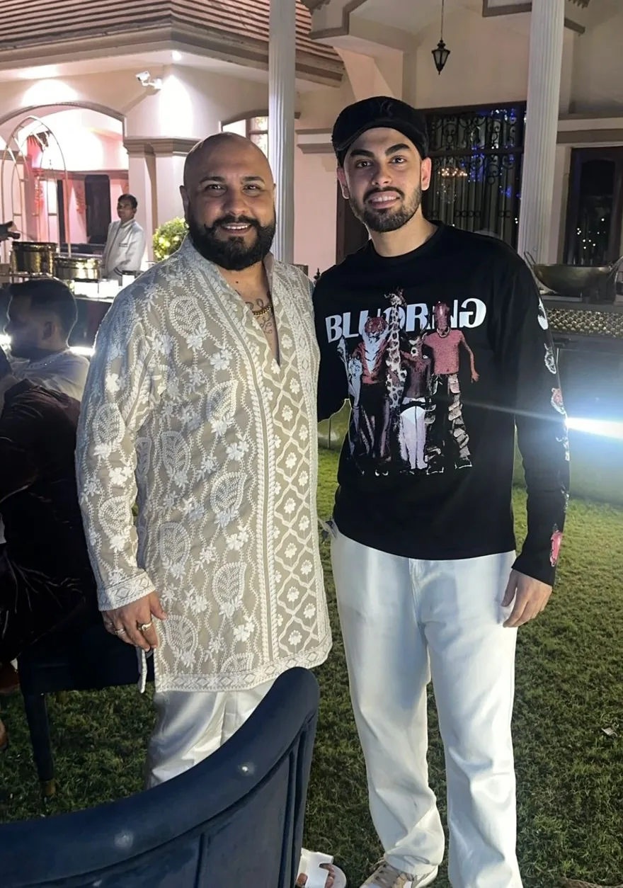 Kaydrop at an outdoor evening event with a guest in a cream chikankari kurta.