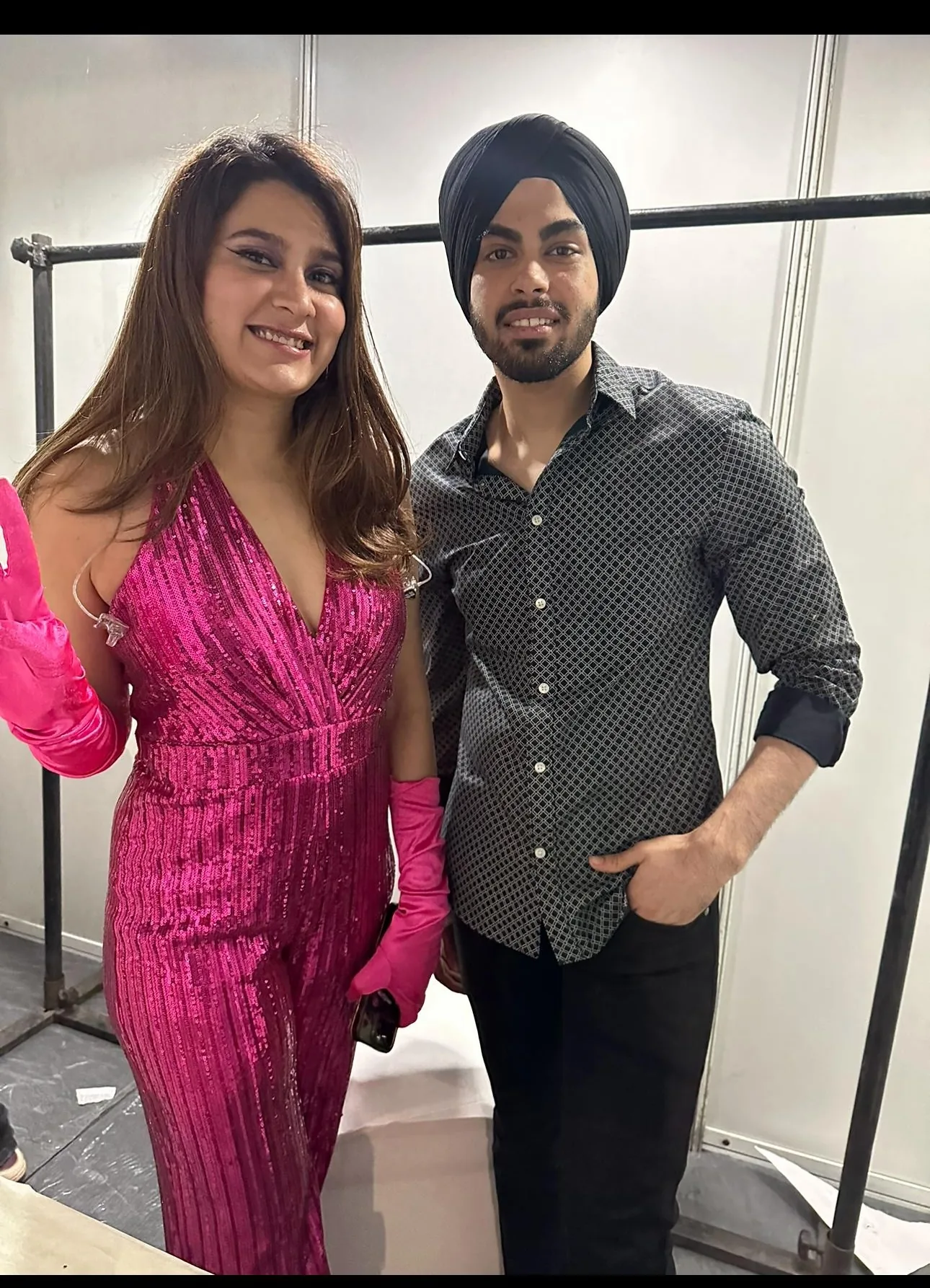 Kaydrop backstage at an event with a guest in a pink sequin outfit.