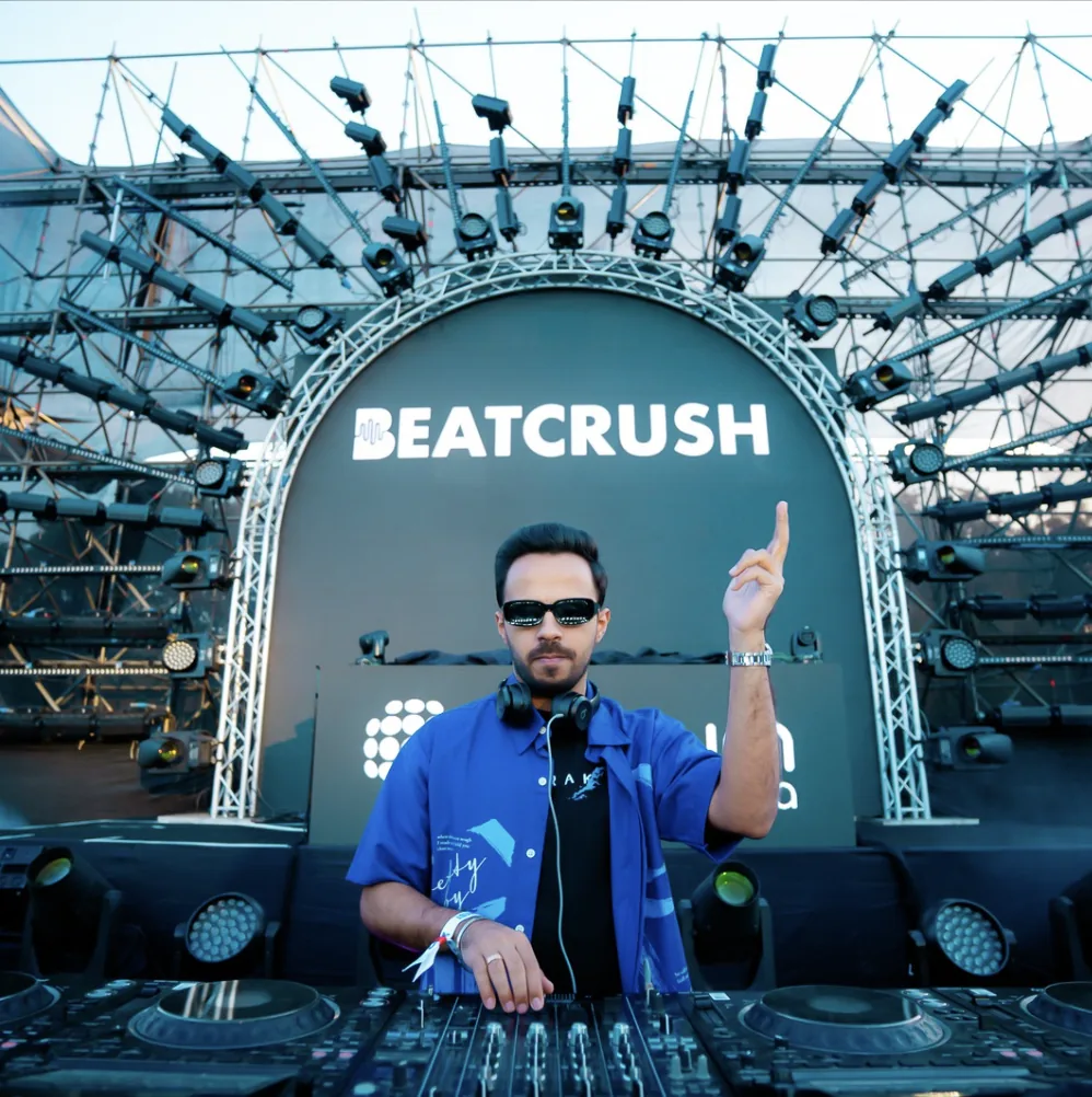 BeatCrush on the main stage under the BEATCRUSH arch, festival lighting rig behind him.
