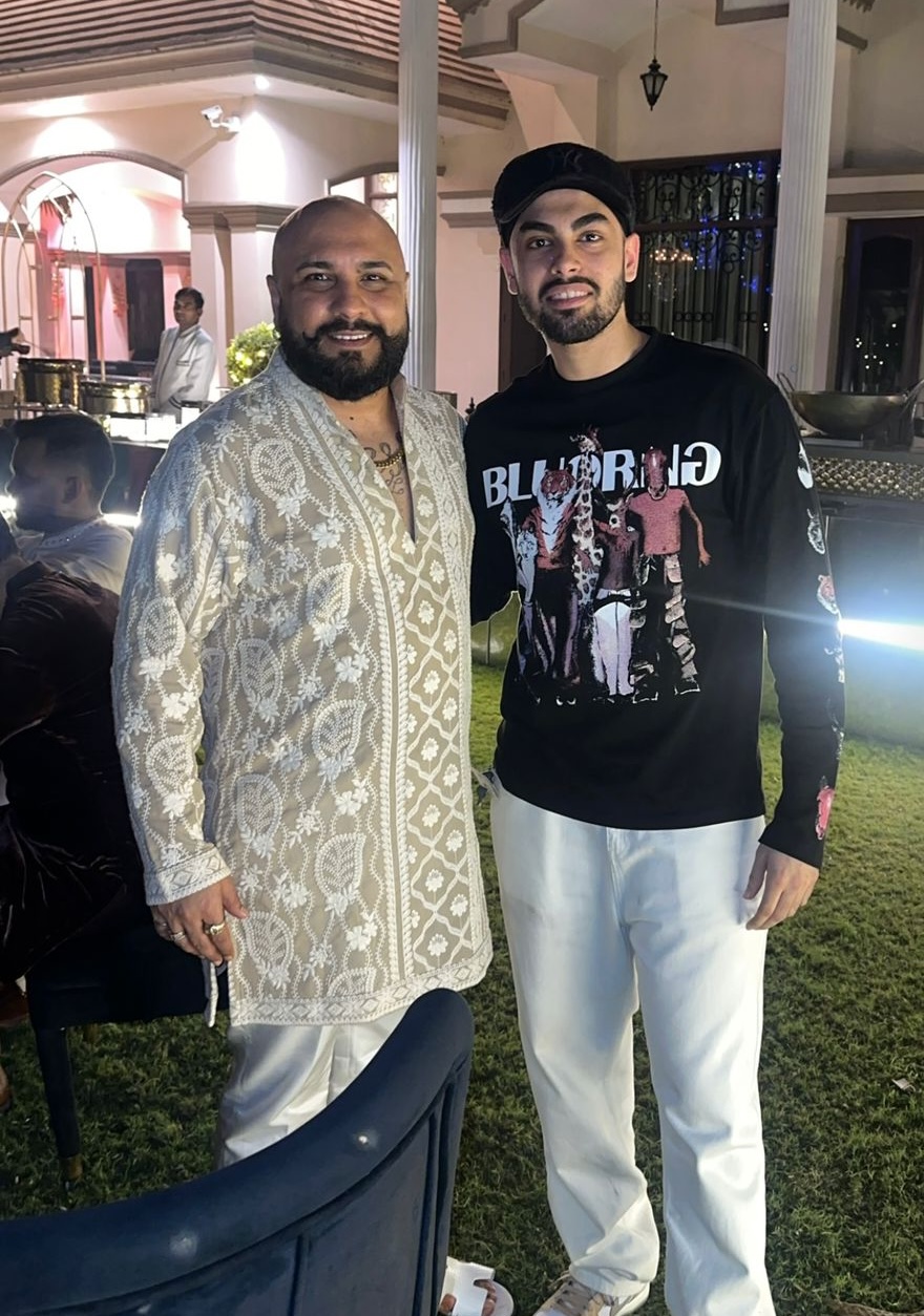 Kaydrop at an outdoor evening event with a guest in a cream chikankari kurta.