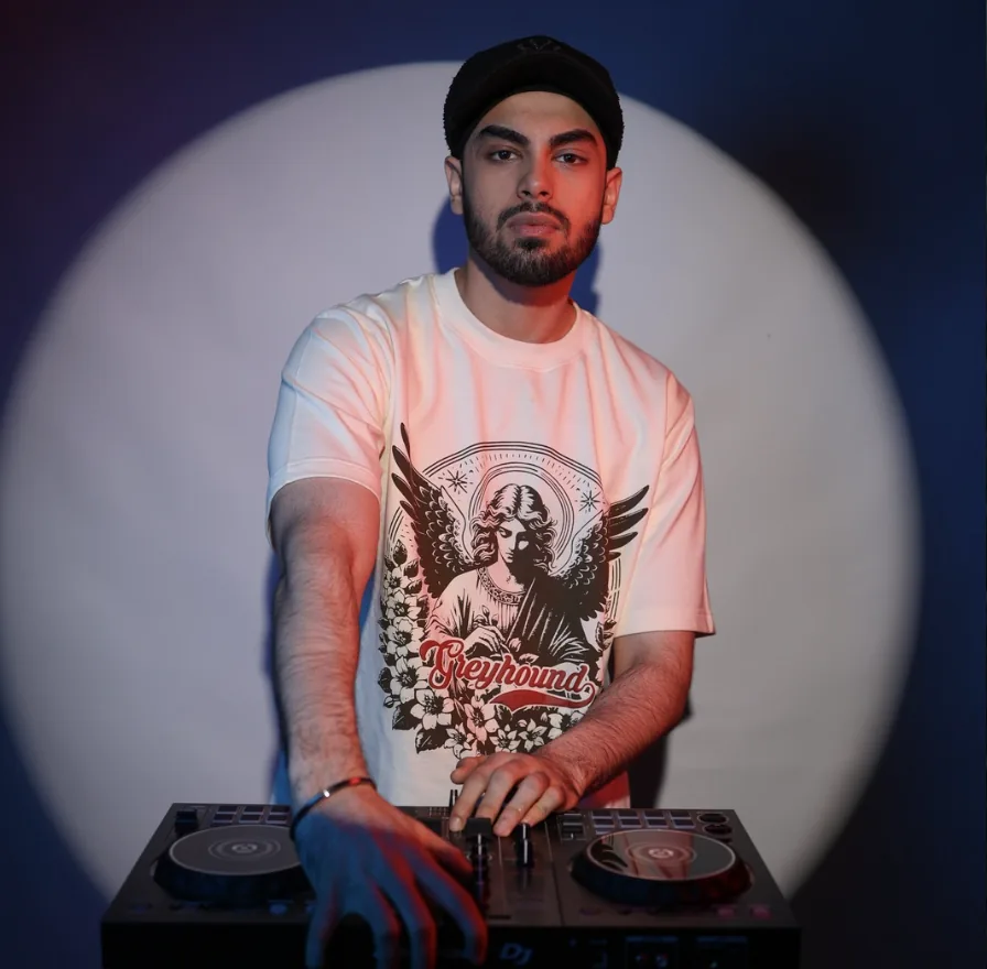 Kaydrop studio portrait under a spotlight, hands on the controller.