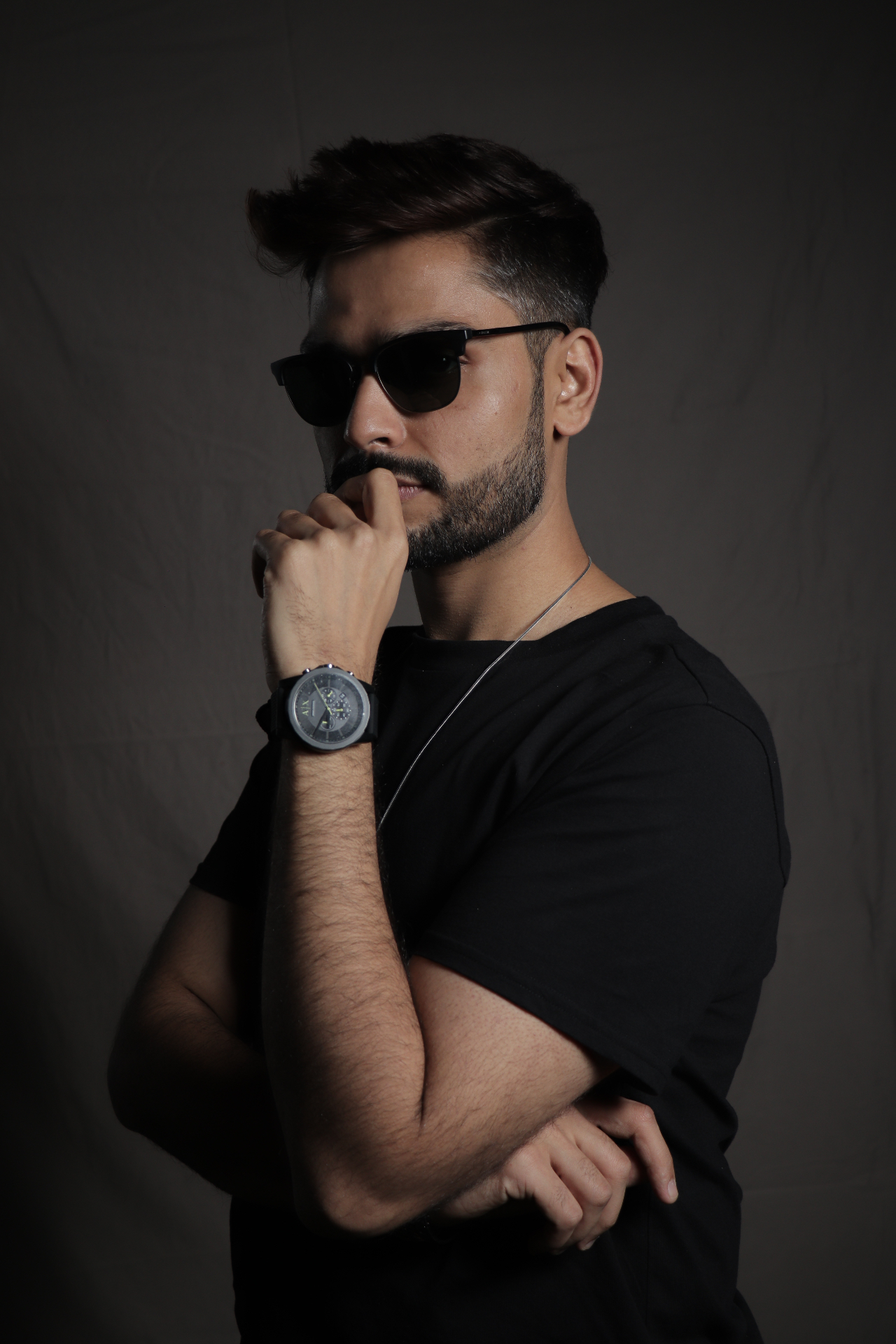 Skopòs side profile portrait in low-key studio light.